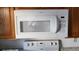 Hotpoint microwave above range in kitchen with wooden cabinets at 315 Indigo Rd, Goose Creek, SC 29445