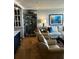 Comfortable living room with neutral decor, display case, and natural lighting at 330 Concord St # 15C, Charleston, SC 29401