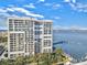 High-rise building with multiple balconies overlooking a waterfront and a bridge in the distance at 330 Concord St # Th 21, Charleston, SC 29401