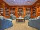 Classic library with floor-to-ceiling bookshelves and comfortable seating for reading and relaxation at 330 Concord St # Th 21, Charleston, SC 29401