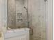Luxurious tiled shower with a glass door and built-in shelving for toiletries at 330 Concord St # Th 21, Charleston, SC 29401