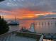 Breathtaking waterfront view with a sunset sky, pier, and boat, enhancing the property's serene and scenic appeal at 330 Concord St # Th 21, Charleston, SC 29401