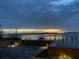 Scenic waterfront view at dusk with bridge and boat, visible from the wooden terrace at 330 Concord St # Th 21, Charleston, SC 29401