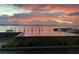 Gorgeous waterfront view with vibrant sunset colors, pier, and boats on the water at 330 Concord St # Th 21, Charleston, SC 29401