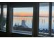 Stunning waterfront view through large windows showing a pier, bridge, and serene sunset at 330 Concord St # Th 21, Charleston, SC 29401
