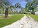 Long driveway lined with lush greenery and mature trees, leading to a secluded property at 330 Crestwood Dr, Moncks Corner, SC 29461