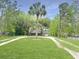 Charming home featuring lush green lawn, mature trees, and a long driveway for ample parking at 330 Crestwood Dr, Moncks Corner, SC 29461