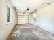 Garage view shows a window for natural light, single car parking, door, and unfinished concrete floor at 330 Crestwood Dr, Moncks Corner, SC 29461