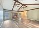 Open living room with vaulted ceiling, wooden beams, fireplace, and new luxury vinyl plank flooring at 330 Crestwood Dr, Moncks Corner, SC 29461