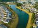 Aerial view of a neighborhood with houses bordering a winding waterway and lush green landscaping at 332 Fish Creek Ct, Summerville, SC 29486