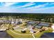 Community aerial showcasing tennis courts, a clubhouse, a pool, and pristine landscaping near a lake at 332 Fish Creek Ct, Summerville, SC 29486