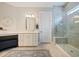 Bright bathroom with a glass-enclosed shower with bench, vanity, and tile flooring at 332 Fish Creek Ct, Summerville, SC 29486
