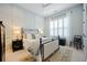 Bright bedroom featuring a decorative accent wall, plantation shutters, and cozy, stylish furnishings at 332 Fish Creek Ct, Summerville, SC 29486