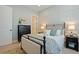 Charming bedroom with neutral tones, paneled accent wall, and stylish furnishings create a cozy retreat at 332 Fish Creek Ct, Summerville, SC 29486