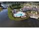 Aerial view of a community pool surrounded by lush landscaping, a clubhouse, and a tranquil lake at 332 Fish Creek Ct, Summerville, SC 29486