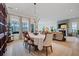 Open-concept design with dining area featuring natural light from large windows and open to the living room with fireplace at 332 Fish Creek Ct, Summerville, SC 29486