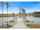 A picturesque view of a serene lake and dock. The scenery provides a tranquil setting for relaxation and nature appreciation at 332 Fish Creek Ct, Summerville, SC 29486