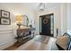 Inviting foyer with light wood floors, stylish console table, rug, and a black front door at 332 Fish Creek Ct, Summerville, SC 29486