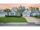 Charming home with a well-manicured lawn, palm trees, and a two-car garage at 332 Fish Creek Ct, Summerville, SC 29486