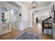 Open hallway with light wood floors, white trim, staircase, and view to the dining area at 332 Fish Creek Ct, Summerville, SC 29486
