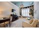 Well-appointed home office with custom built-ins, neutral decor, and a stylish chandelier at 332 Fish Creek Ct, Summerville, SC 29486