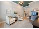 Comfortable office space featuring two chairs, a large flower vase and French doors to the foyer at 332 Fish Creek Ct, Summerville, SC 29486