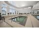 Relaxing indoor hot tub area with clear water, safety features, and large windows for natural light at 332 Fish Creek Ct, Summerville, SC 29486
