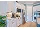This kitchen showcases stainless steel appliances, white cabinetry, and ample counter space at 332 Fish Creek Ct, Summerville, SC 29486