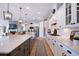 Bright kitchen with a large island, white cabinets, stainless steel appliances, and modern lighting at 332 Fish Creek Ct, Summerville, SC 29486