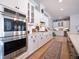 This kitchen showcases stainless steel appliances, white cabinetry, and offers ample counter space at 332 Fish Creek Ct, Summerville, SC 29486