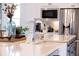 Close-up of a stylish kitchen sink with white countertops and stainless steel appliances in background at 332 Fish Creek Ct, Summerville, SC 29486
