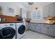Well-organized laundry room featuring modern appliances, storage cabinets, and stylish countertops at 332 Fish Creek Ct, Summerville, SC 29486