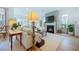 Cozy living room with a fireplace and TV on a gray accent wall, complemented by natural light from large windows at 332 Fish Creek Ct, Summerville, SC 29486