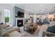 Open-concept living space with a modern fireplace and a large kitchen island with seating, providing a cozy atmosphere at 332 Fish Creek Ct, Summerville, SC 29486