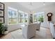 Bright sunroom with large windows offering scenic views, comfortable seating, and hardwood floors at 332 Fish Creek Ct, Summerville, SC 29486