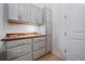 Well-organized gray cabinet space with butcher block countertop, drawers, and storage at 332 Fish Creek Ct, Summerville, SC 29486