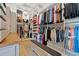 Well-appointed walk-in closet with ample hanging space, shelving, and central bench at 332 Fish Creek Ct, Summerville, SC 29486