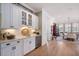 The bar area features custom cabinetry, a wine fridge, and seamless flow into the dining area at 332 Fish Creek Ct, Summerville, SC 29486