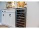 Built-in wine cooler in the kitchen area, complementing the white cabinetry and countertop with wine bottles inside at 332 Fish Creek Ct, Summerville, SC 29486