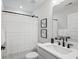 Clean, modern bathroom with black hardware, art on the walls, and a shower curtain at 333 Bremerton Dr, Goose Creek, SC 29445