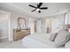 Spacious bedroom with tray ceilings, soft carpet, neutral tones, and a dresser with mirror at 333 Bremerton Dr, Goose Creek, SC 29445