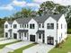 Modern white townhomes with black trim, garages, well-manicured lawns and landscaping at 333 Bremerton Dr, Goose Creek, SC 29445
