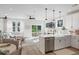Bright, open-concept living space with hardwood floors, modern lighting, and a stylish kitchen with stainless steel appliances at 333 Bremerton Dr, Goose Creek, SC 29445