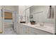Bright bathroom featuring double sinks with white cabinetry and modern fixtures, next to a bathtub at 3424 Henrietta Hartford Rd, Mount Pleasant, SC 29466