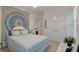 Bedroom featuring a light blue bed, a vibrant mandala tapestry, and bright natural light at 3424 Henrietta Hartford Rd, Mount Pleasant, SC 29466