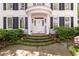 Inviting front entrance with elegant columns, a balcony, and meticulously landscaped steps, creating a warm and welcoming ambiance at 3424 Henrietta Hartford Rd, Mount Pleasant, SC 29466
