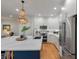 Bright kitchen boasts an island with marbled countertops, stainless steel appliances, and stylish chandelier lighting at 3424 Henrietta Hartford Rd, Mount Pleasant, SC 29466