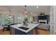Open-concept kitchen with island seating, stainless steel appliances, and a view into the living room at 3424 Henrietta Hartford Rd, Mount Pleasant, SC 29466
