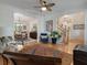 Cozy living room with hardwood floors, ceiling fan, and view into the dining room at 3424 Henrietta Hartford Rd, Mount Pleasant, SC 29466