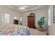 Bright main bedroom with a ceiling fan, an ensuite bathroom, and ample storage space in a wooden cabinet at 3424 Henrietta Hartford Rd, Mount Pleasant, SC 29466